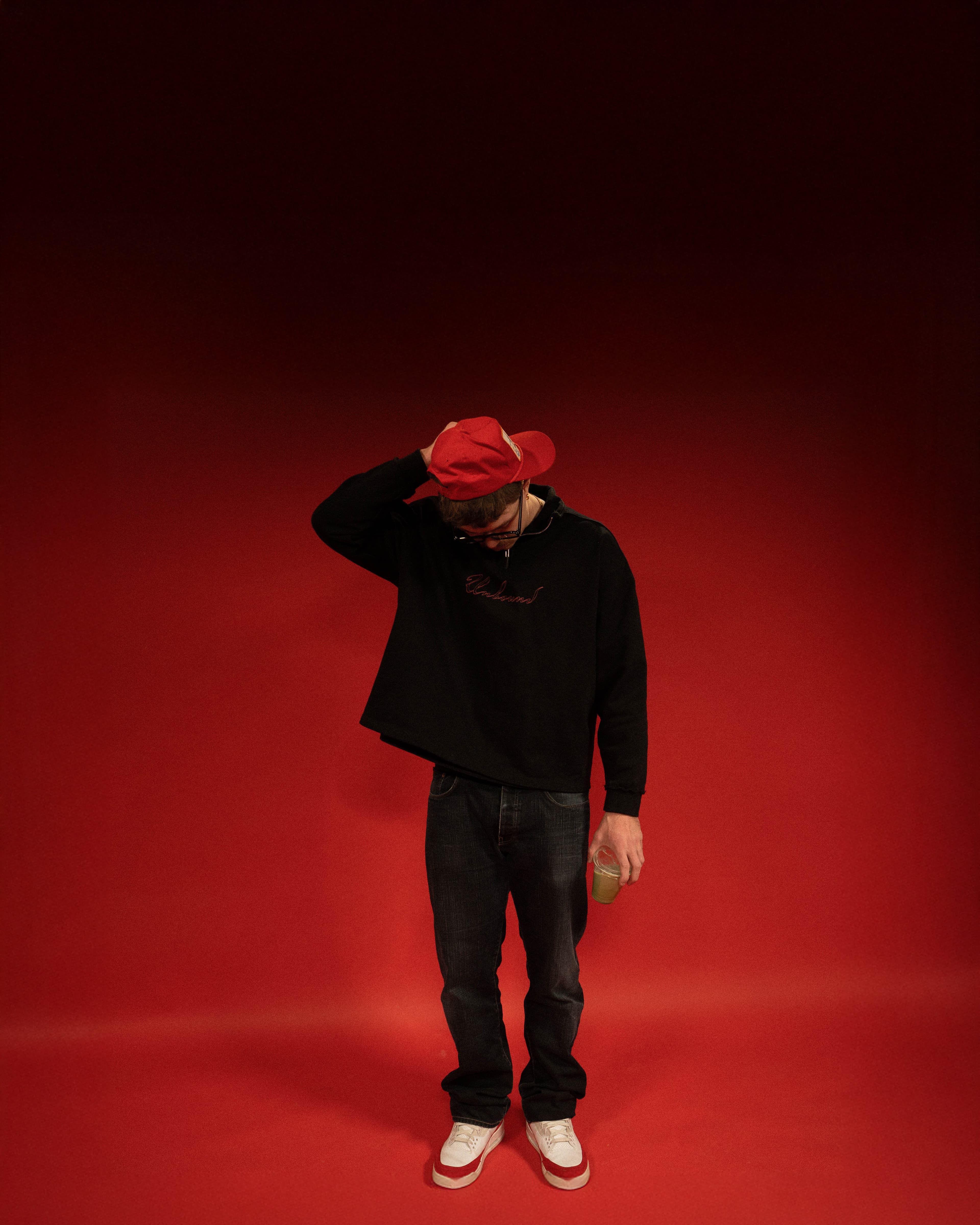 Kade Gilbertson standing against a red backdrop